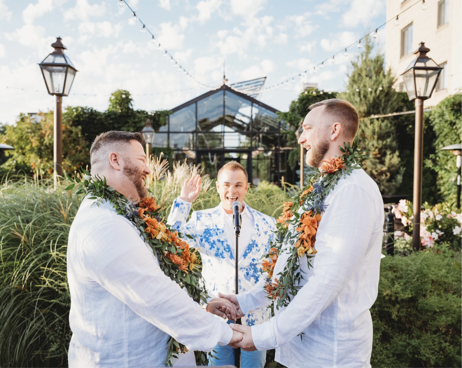LGBTQ garden wedding ceremony with officiant Schwa Potter and two grooms wearing leis