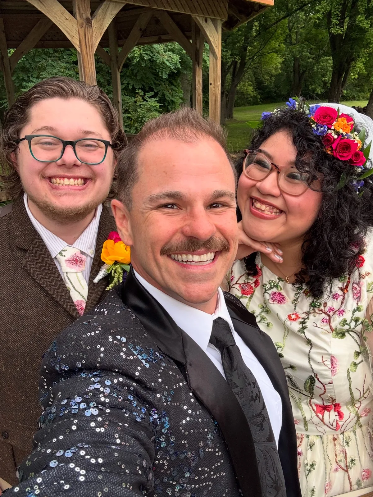 Wedding officiant selfie with couple at outdoor park ceremony
