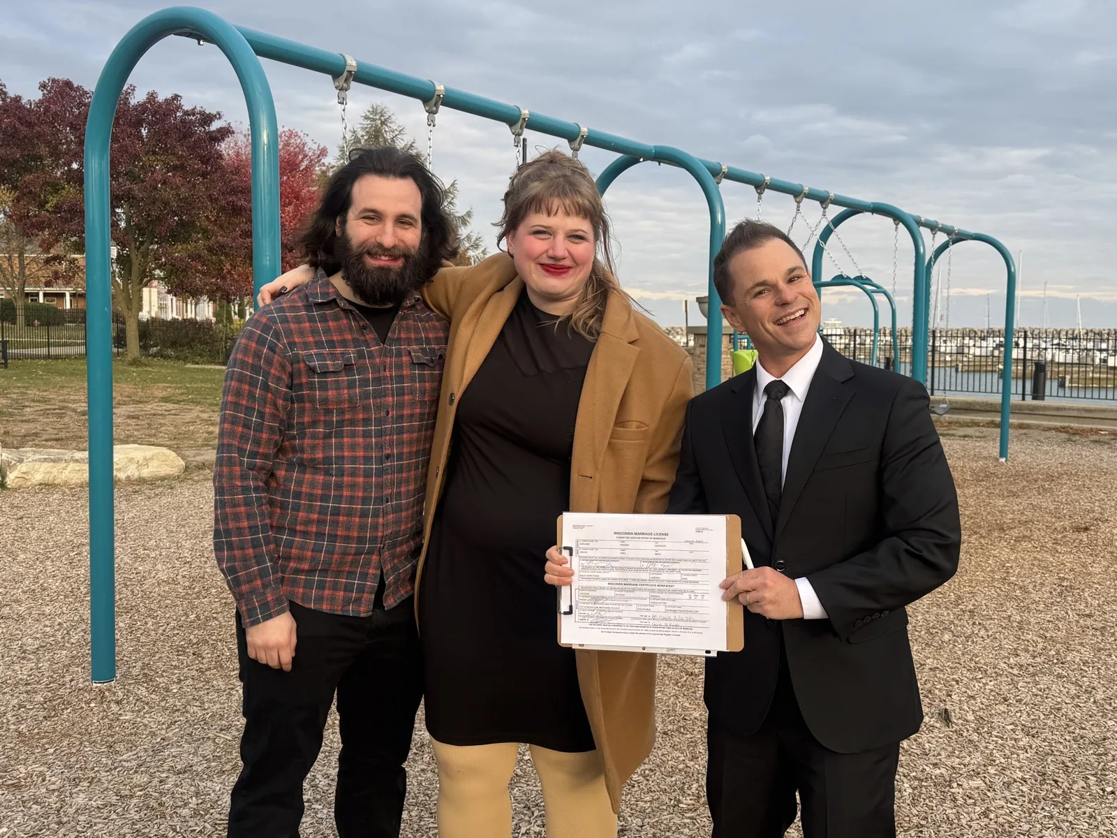 Couple with marriage license after ceremony with Schwa Potter