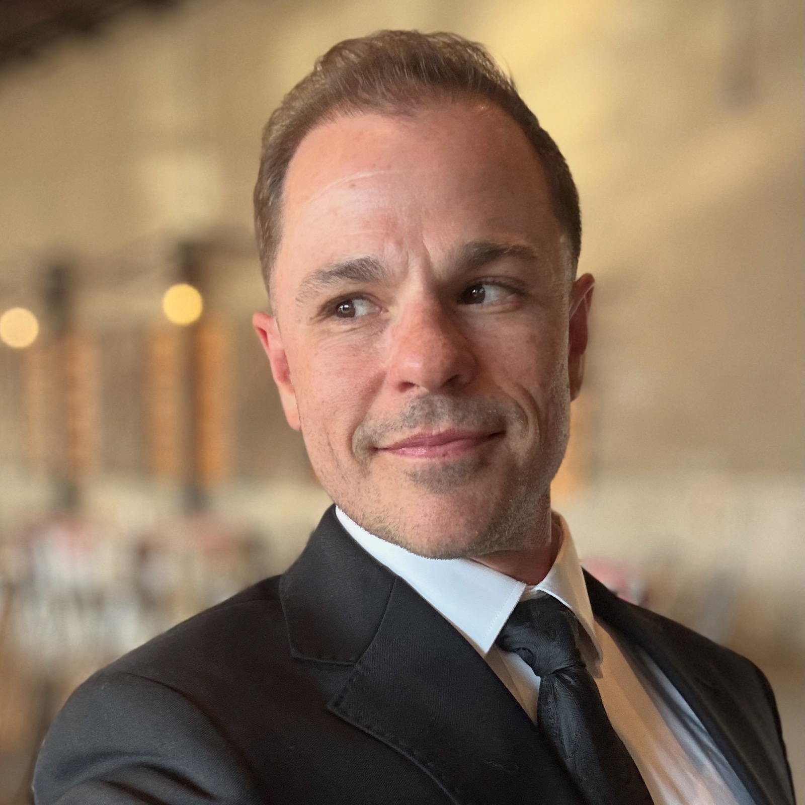 Milwaukee wedding officiant Schwa Potter smiling in a professional portrait